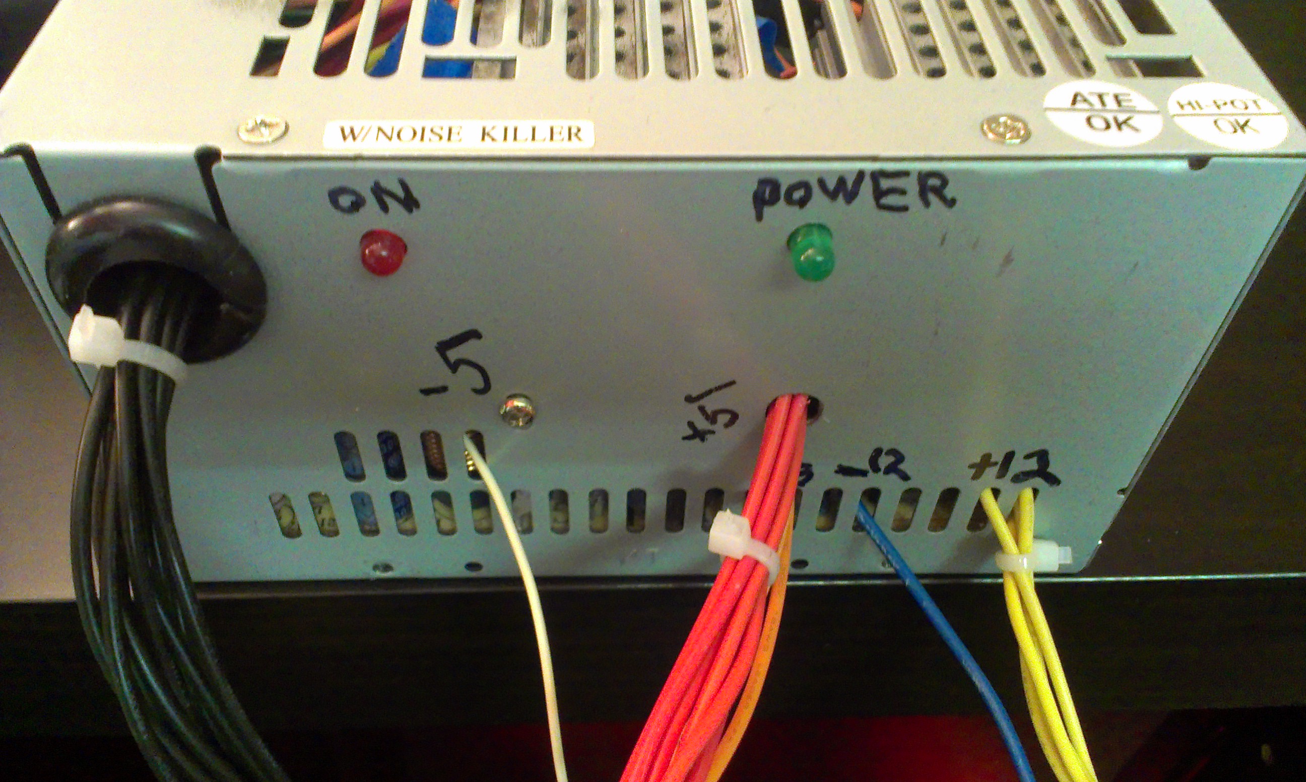 The front of the hacked power supply with labelled leads and power LEDs